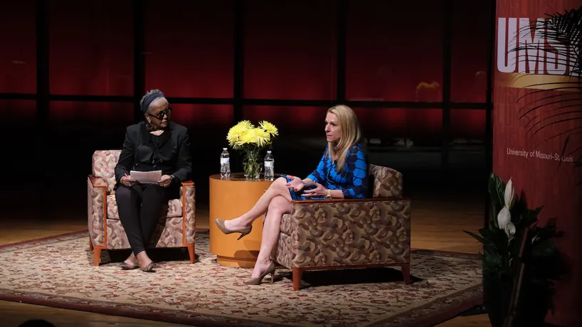 Rebecca Boyer, right, speaking on stage at UMSL's Distinguished Speaker Series
